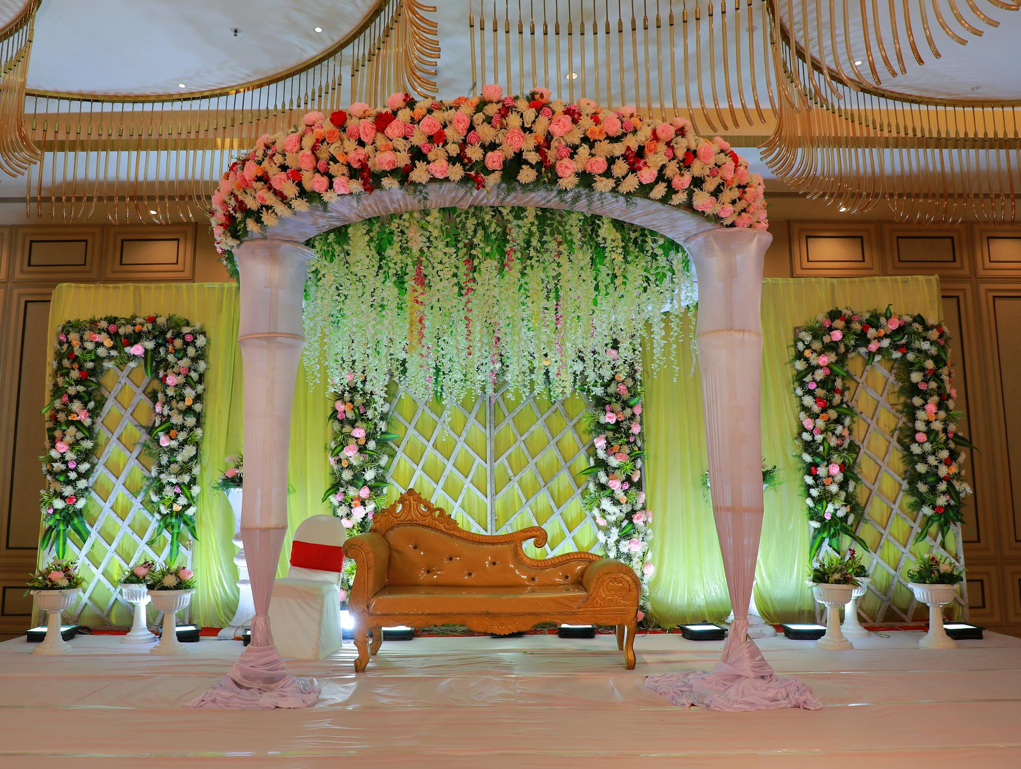 Pricing Luxurious wedding stage adorned with vibrant flowers and elegant design, perfect for celebrations.